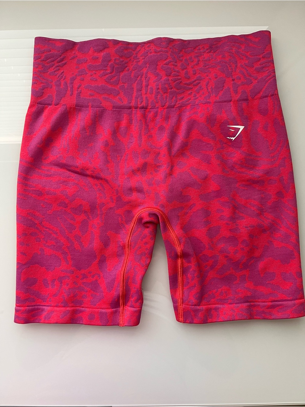 Gymshark seamless high-rise bike shorts in bold magenta and pink tones.